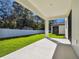 Covered patio overlooking the backyard with a white fence at 11311 Striped Bass Ct, New Port Richey, FL 34654