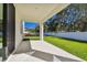 Covered patio with view of the green lawn at 11311 Striped Bass Ct, New Port Richey, FL 34654