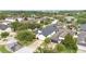 Aerial view of a home with a dark roof in a neighborhood surrounded by lush green trees at 12721 Avelar Creek Dr, Riverview, FL 33578