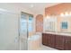 Bathroom featuring a double vanity, soaking tub, glass shower and a large window at 12721 Avelar Creek Dr, Riverview, FL 33578