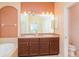 Bathroom featuring a double vanity and modern lighting fixtures above the mirror at 12721 Avelar Creek Dr, Riverview, FL 33578