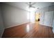 Spacious bedroom with light walls, wood floors, and a ceiling fan with access to the bright en-suite bathroom at 12721 Avelar Creek Dr, Riverview, FL 33578