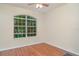 Bedroom featuring a large window and wood floors, offering a bright and airy feel at 12721 Avelar Creek Dr, Riverview, FL 33578