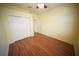 Bedroom featuring light yellow walls, hardwood floors, a ceiling fan, and a closet with folding doors at 12721 Avelar Creek Dr, Riverview, FL 33578