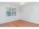 Empty room with hardwood floors and bright window at 12721 Avelar Creek Dr, Riverview, FL 33578