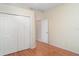 Bedroom with closet, wood floors, and a neutral color scheme; ideal for personalization at 12721 Avelar Creek Dr, Riverview, FL 33578