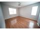 Empty room with hardwood floors, bright window and ceiling fan at 12721 Avelar Creek Dr, Riverview, FL 33578