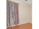 Bedroom featuring a window with curtains, wood floors, and soft neutral walls at 12721 Avelar Creek Dr, Riverview, FL 33578