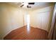 This bedroom includes wood floors, a ceiling fan, closet and a bright window at 12721 Avelar Creek Dr, Riverview, FL 33578