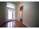 Inviting entryway with wood floors and glass front door, creating a warm and welcoming ambiance at 12721 Avelar Creek Dr, Riverview, FL 33578