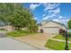 Charming single-story home with a two-car garage, manicured lawn, and mature landscaping at 12721 Avelar Creek Dr, Riverview, FL 33578