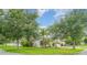 Exterior view of home with lush landscaping and a well-manicured lawn on a sunny day at 12721 Avelar Creek Dr, Riverview, FL 33578