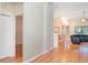 Hallway with hardwood floors, and decorative wall finish, leading to a comfortable living room at 12721 Avelar Creek Dr, Riverview, FL 33578