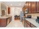 Well-lit kitchen featuring stainless steel appliances and warm-toned cabinetry at 12721 Avelar Creek Dr, Riverview, FL 33578