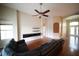A well-lit living area featuring a fan and sleek wood flooring, perfect for relaxation at 12721 Avelar Creek Dr, Riverview, FL 33578