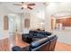 A spacious living room opens to the kitchen with dark cabinets and stainless steel appliances at 12721 Avelar Creek Dr, Riverview, FL 33578