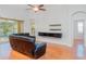 Spacious living room with modern black media center and hardwood floors at 12721 Avelar Creek Dr, Riverview, FL 33578