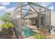 The backyard features a screened-in pool, tropical landscaping, and a covered lanai at 12721 Avelar Creek Dr, Riverview, FL 33578