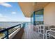 Balcony with table and chairs overlooking the ocean and cityscape, ideal for relaxation at 1540 Gulf Blvd # 2107, Clearwater Beach, FL 33767