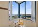 Enjoy panoramic city views from this window alcove, complete with a cozy chair and a charming side table at 1540 Gulf Blvd # 2107, Clearwater Beach, FL 33767