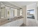 Bright bathroom features double sinks, ample counter space, and a doorway leading to the rest of the house, plus a water view at 1540 Gulf Blvd # 2107, Clearwater Beach, FL 33767