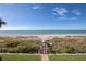 Direct beach access featuring a well-maintained walkway over lush, grassy dunes at 1540 Gulf Blvd # 2107, Clearwater Beach, FL 33767