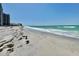 Beautiful oceanfront beach with clear blue water, gentle waves, and white sand at 1540 Gulf Blvd # 2107, Clearwater Beach, FL 33767