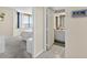Bedroom leading to a bathroom and offering views of the city from its large windows at 1540 Gulf Blvd # 2107, Clearwater Beach, FL 33767