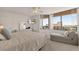 Well-lit bedroom with a city view, comfortable lounger, and flat screen television at 1540 Gulf Blvd # 2107, Clearwater Beach, FL 33767