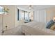 Comfortable bedroom with large window providing city views, a lounger and flat screen television at 1540 Gulf Blvd # 2107, Clearwater Beach, FL 33767