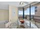A dining area showcasing a glass table with seating and large windows offering scenic views at 1540 Gulf Blvd # 2107, Clearwater Beach, FL 33767