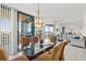 Open dining room with tile floors, chandelier and access to balcony with ocean views at 1540 Gulf Blvd # 2107, Clearwater Beach, FL 33767