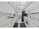Bright white kitchen with modern appliances and an adjacent dining area with beautiful natural light at 1540 Gulf Blvd # 2107, Clearwater Beach, FL 33767