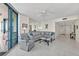 Bright living room with tile floors, ceiling fan, sliding glass doors and comfortable seating at 1540 Gulf Blvd # 2107, Clearwater Beach, FL 33767