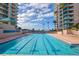 Lap pool featuring crisp blue water, dividing lines, palm trees, lounge chairs and condominium buildings at 1540 Gulf Blvd # 2107, Clearwater Beach, FL 33767