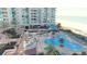 Aerial view of a condo building with landscaped terrace, pool, hot tub, lounge chairs and ocean views at 1540 Gulf Blvd # 2107, Clearwater Beach, FL 33767