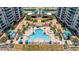 A gorgeous pool area featuring plenty of lounge chairs and tropical landscaping at 1540 Gulf Blvd # 2107, Clearwater Beach, FL 33767