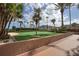 Professionally maintained putting green surrounded by palm trees and a manicured landscape at 1540 Gulf Blvd # 2107, Clearwater Beach, FL 33767