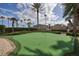 Immaculate putting green encircled by well-kept landscaping and palm trees at 1540 Gulf Blvd # 2107, Clearwater Beach, FL 33767
