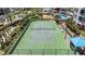 Aerial view of a well-maintained tennis court surrounded by lush landscaping at 1540 Gulf Blvd # 2107, Clearwater Beach, FL 33767