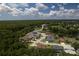 Aerial view of a community featuring lush trees, ponds and well-manicured lawns on a partly cloudy day at 16304 Wild Mallard Dr, Odessa, FL 33556