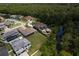 Aerial view of a luxury home with a pool, outdoor kitchen and gorgeous landscaping near a creek at 16304 Wild Mallard Dr, Odessa, FL 33556