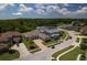 Aerial view of homes with manicured lawns and mature trees in a neighborhood near a lush green space at 16304 Wild Mallard Dr, Odessa, FL 33556