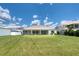Expansive backyard featuring a well-maintained lawn and a covered, screened-in porch at 16304 Wild Mallard Dr, Odessa, FL 33556