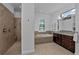 Bathroom features a tub, large shower and a vanity with lots of counter space at 16304 Wild Mallard Dr, Odessa, FL 33556