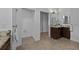 Bright bathroom features a granite countertop vanity and a separate toilet room at 16304 Wild Mallard Dr, Odessa, FL 33556