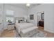 Cozy bedroom with neutral tones and built in bench with drawers at the foot of the bed at 16304 Wild Mallard Dr, Odessa, FL 33556