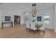 Dining room with hardwood floors and modern lighting, adjacent to the office and foyer at 16304 Wild Mallard Dr, Odessa, FL 33556