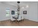 Dining area with wood floors, modern lighting, and bright, natural light from multiple windows at 16304 Wild Mallard Dr, Odessa, FL 33556