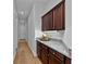 Hallway features beautiful wooden floors and a granite countertop with cabinets underneath and overhead at 16304 Wild Mallard Dr, Odessa, FL 33556
